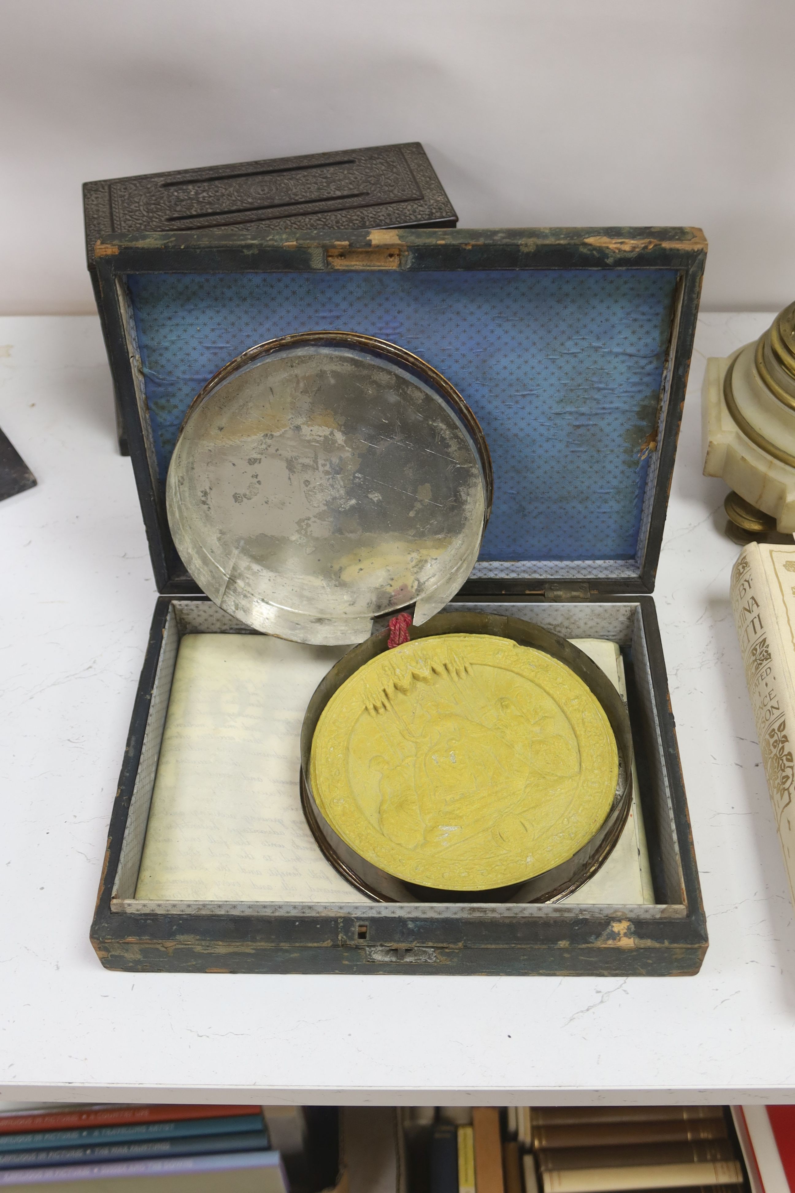 A James Cockings leather box containing a vellum patent letter with Queen Victoria Grand seal with an Indian carved box, pen stand etc